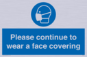 please-continue-to-wear-a-face-covering~